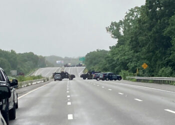 This photo provided by Massachusetts State Police shows police blocking off a section of Interstate 95 near Wakefield, Mass., on Saturday, July 3, 2021.  Police say a group of heavily-armed men refuse to comply with law enforcement officers following a traffic stop. Police say the men headed into a wooded area and two suspects were arrested a short time later. Officials were still trying to capture the others in the group  ( Massachusetts State Police via AP)